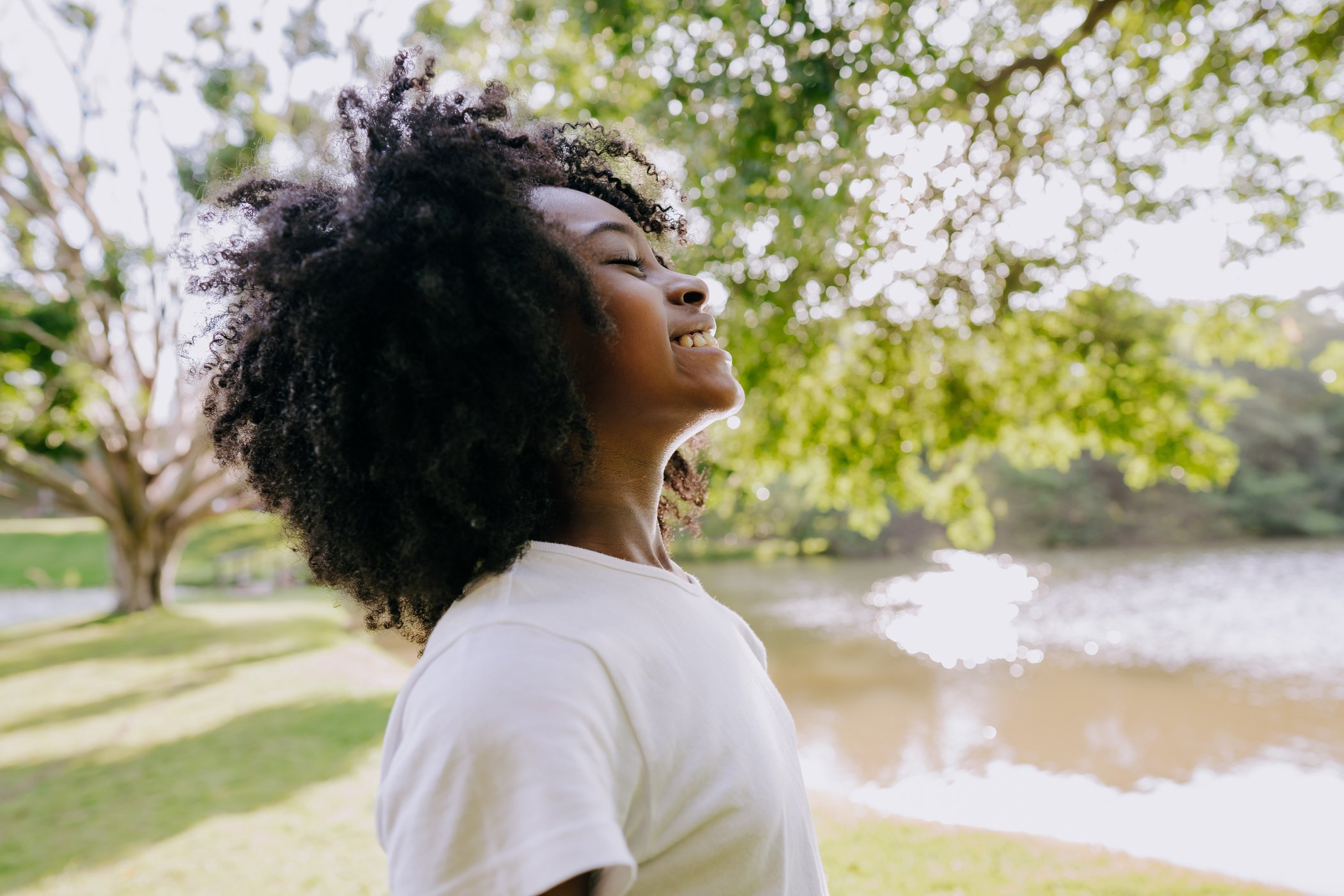 A child breathing clean air in nature smiling